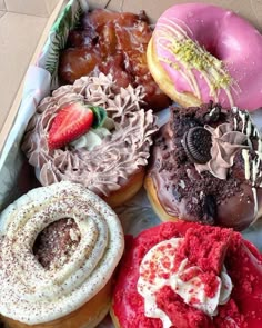 a box filled with lots of different flavored donuts