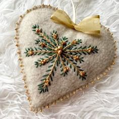 an ornament shaped like a snowflake on white fur with gold trim