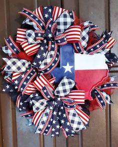 a wreath with the state of texas painted in red, white and blue on it