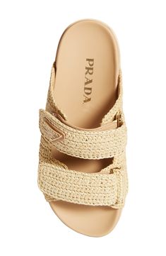 A chunky lug sole grounds this warm-weather-classic double-band sandal clad in braided raffia and furnished with a comfortable contoured footbed. 1" platform Adjustable hook-and-loop straps Contoured footbed Textile upper/leather lining/synthetic sole Made in Italy Designer Shoes Luxury Footbed Sandals For Spring Vacation, Pradra Shoes, Tropical Vacation Shoes, Dune London Sandals, Luxury Summer Wedge Sandals, Luxury Woven Leather Sandals For Vacation, Luxury Straw Sandals With Woven Sole, Designer Sandals With Woven Straw Sole, Designer Beach Slides With Cushioned Footbed