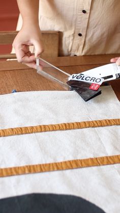 a person cutting fabric with scissors on a table