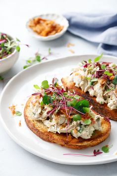 two pieces of bread with chicken salad on it