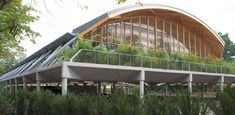 a building with plants growing on the roof