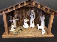 a wooden nativity scene with figurines in it