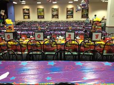 tables and chairs are set up for a birthday party with decorations on the table top