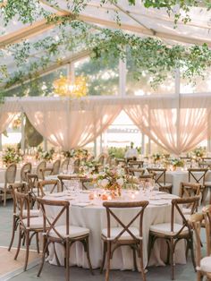 an outdoor tent with tables and chairs set up for a wedding reception in the shade