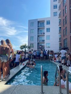 many people are gathered around the pool to take a dip