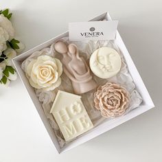 a box with some flowers and soaps in it