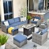 an outdoor living room with blue couches and chairs on the patio area next to a building