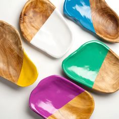 four wooden spoons with different colors on them