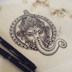 two markers are next to a drawing of an elephant's head and the other one is drawn in black ink