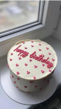 a birthday cake sitting on top of a window sill