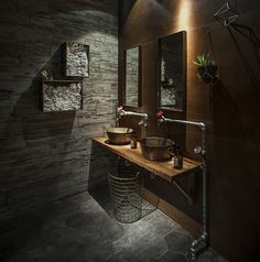 a bathroom with stone walls and two sinks