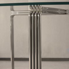 a glass table with four metal legs