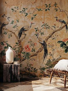 the wallpaper in this room is decorated with birds and flowers, while another bird perches on a tree branch