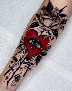 a tattoo with an eye and roses on the arm, in black and grey colors