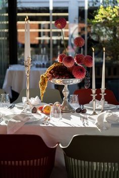 the table is set with candles, flowers and other things to eat in it for dinner