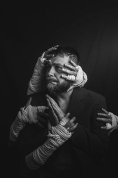 a man is covering his face with hands