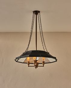 a chandelier hanging from the ceiling with three lights on each side and one light in the middle