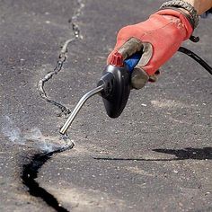 Learn how to do asphalt repair to pits the right way. They're more than just an eyesore; they actually speed up the wear of your driveway. Asphalt Driveway, Family Handyman, Vintage Industrial, Driveway, Geometric Pattern, Repair, How To Wear, Pins