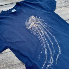 a blue t - shirt with an image of a jellyfish on it