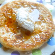 a plate topped with pancakes covered in syrup and ice cream