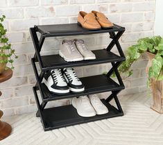 three tiered shoe rack with two pairs of shoes on top and one pair of sneakers below