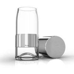 an empty glass next to a metal container