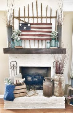 an american flag is on top of a fireplace mantel with vases and books