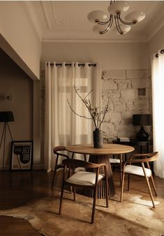 a table and chairs in a room with white curtains