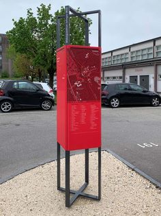 a red sign sitting in the middle of a parking lot