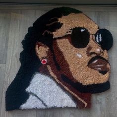 a rug with a man's face and sunglasses on the floor next to a door