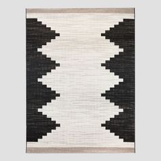 a black and white rug hanging on the wall