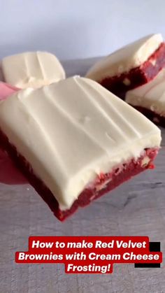 someone is holding up some red velvet brownies with cream cheese frosting