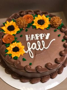 a chocolate cake decorated with sunflowers and the words happy fall