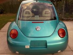 a small blue car parked on the sidewalk