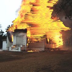 a house on fire with flames coming from it