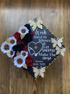 a graduation cap decorated with flowers and butterflies