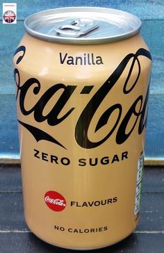 a can of coca - cola zero sugar sits on the ground in front of a blue wall