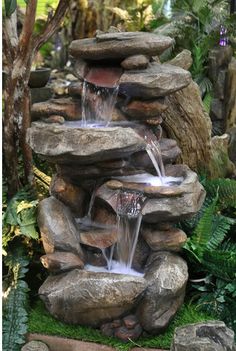 there is a small waterfall in the middle of some rocks