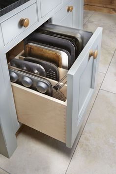 an open drawer in the middle of a kitchen