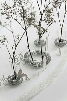 several metal sculptures sitting on top of a white table