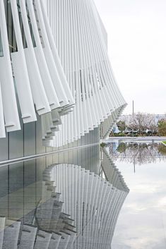 an architectural building reflecting in the water