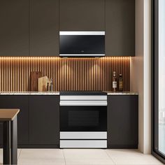 a modern kitchen with black cabinets and stainless steel appliances