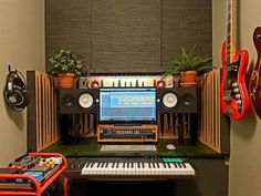 a guitar, keyboard and other musical equipment in a room