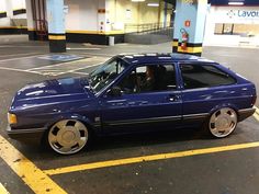 a blue car parked in a parking lot