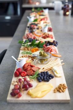 a long wooden table topped with lots of different types of food on top of it