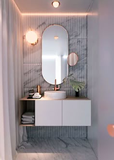 a bathroom with a sink, mirror and lights