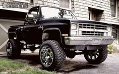 a black truck parked in front of a building