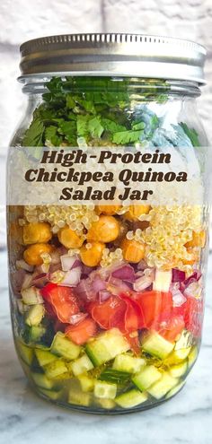 a jar filled with chickpea quinoa salad